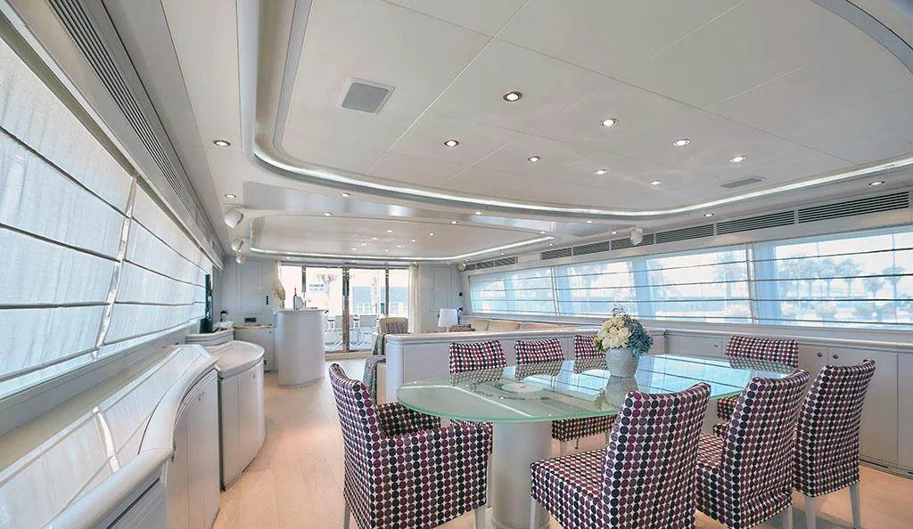 Interior dining table and saloon seating area aboard Camarik