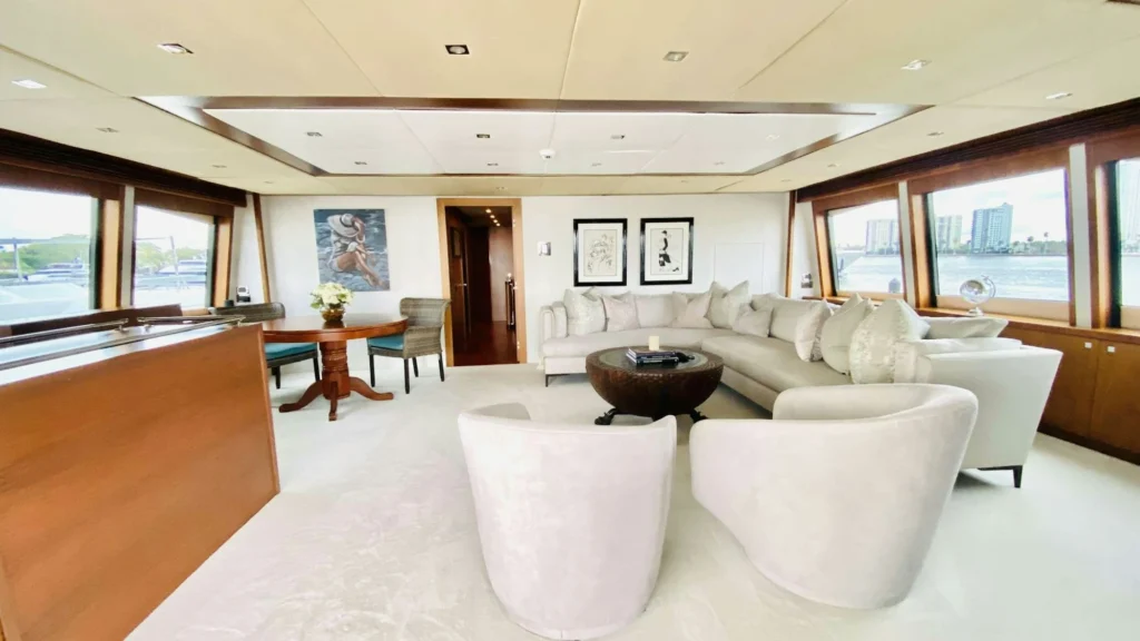 Main salon aboard About Time with seating and dining area