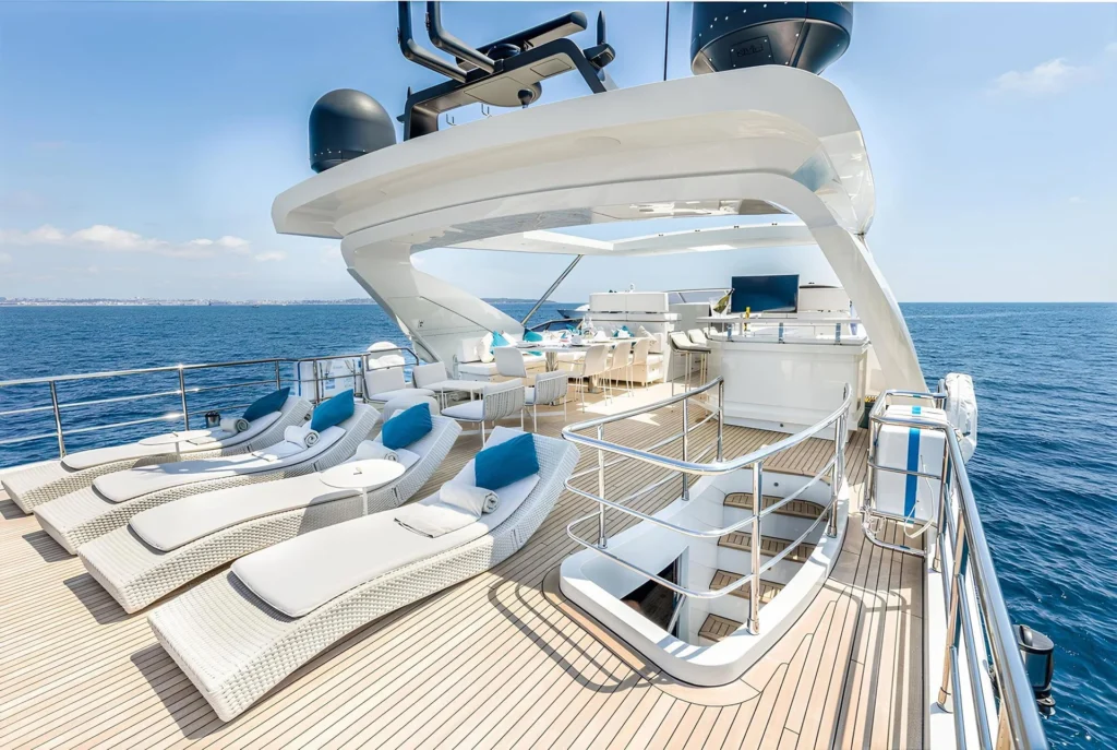 Aft sun deck aboard Anastasia V with loungers and dining area