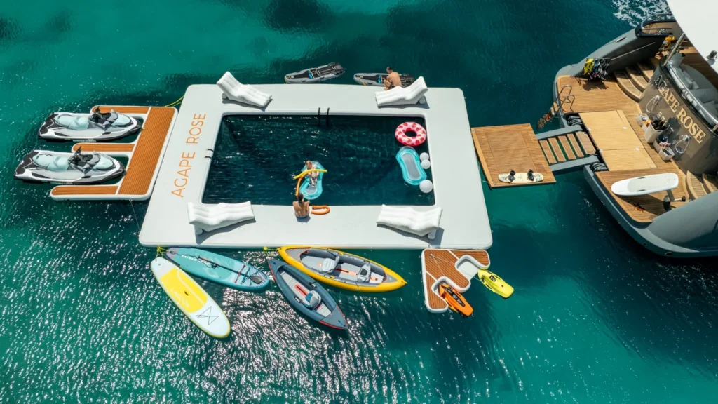 Water toys platform with jet skis and paddleboards astern of Agape Rose
