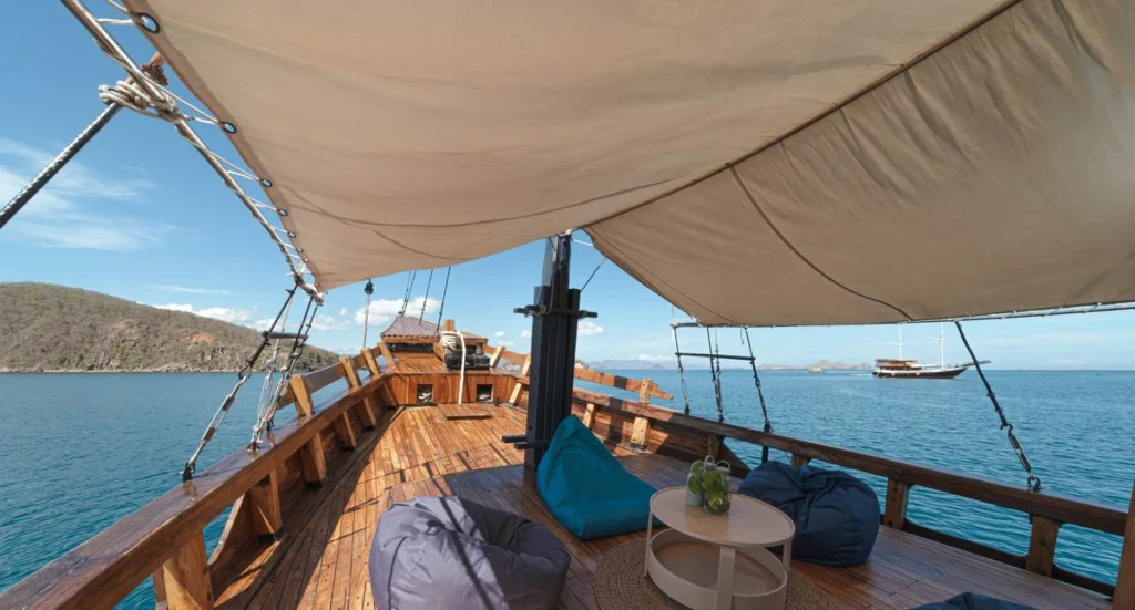 Augustine Phinisi foredeck lounge with bean bags overlooking Komodo waters