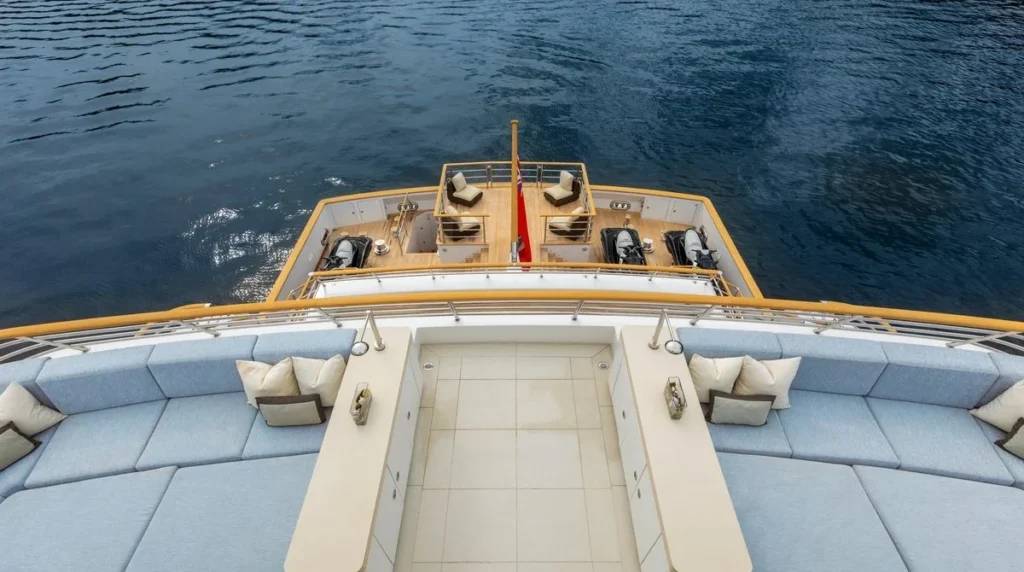 Kogo superyacht aerial view of the stern swim platform with two jet skis, teak sun pad seating and flagpole