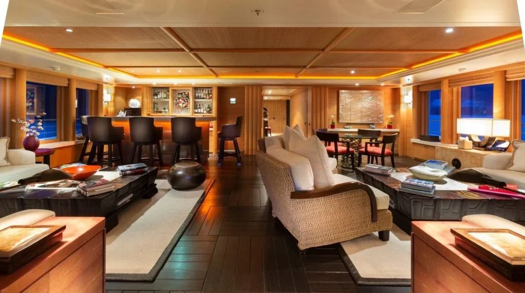 Kogo superyacht interior main salon with bar, lounge seating and dining area