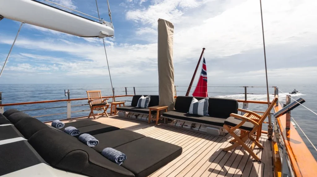 Southern Cloud yacht aft deck at anchor with lounge cushions and towels set out