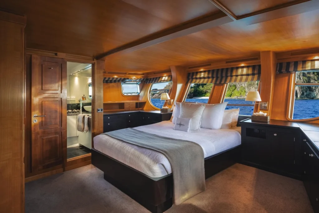 Southern Cloud master cabin with double bed, portholes, and ensuite bathroom