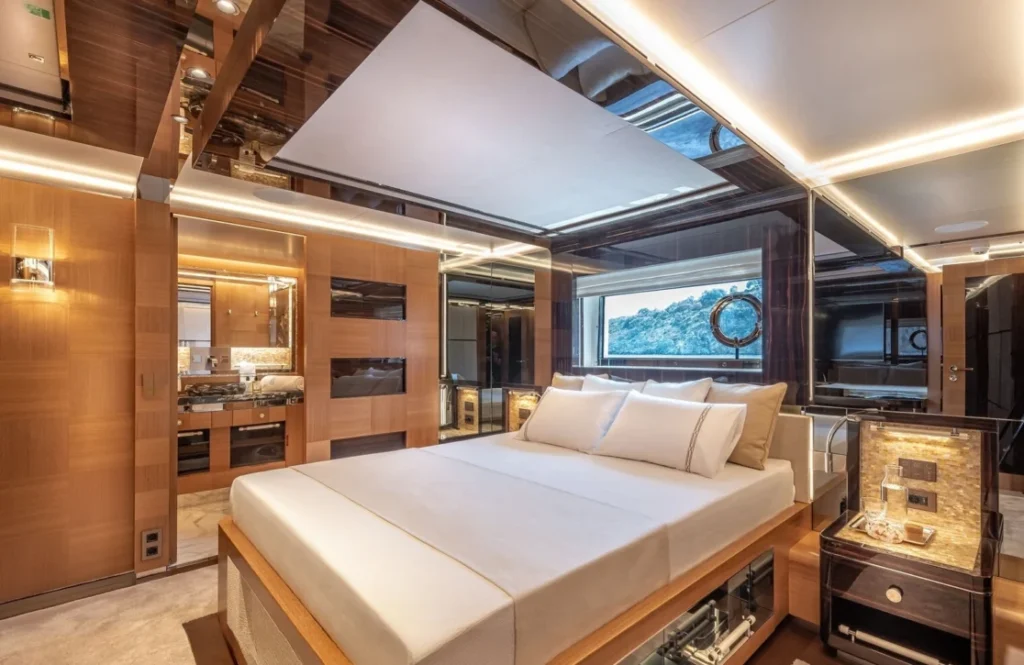 Master cabin aboard Sunrise yacht with a large bed and wood-paneled walls