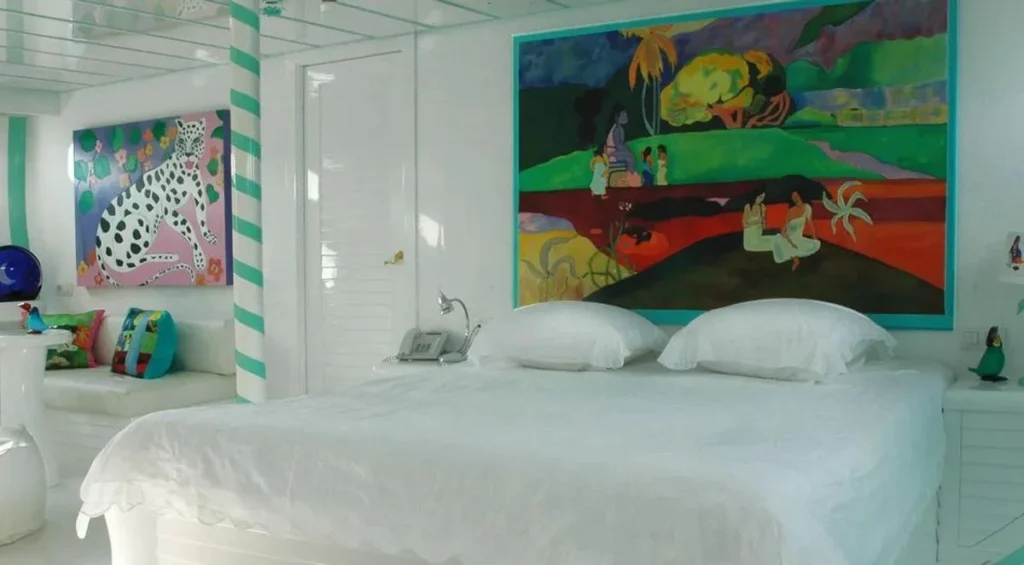 Master cabin double bed with colorful artwork aboard Mata Mua