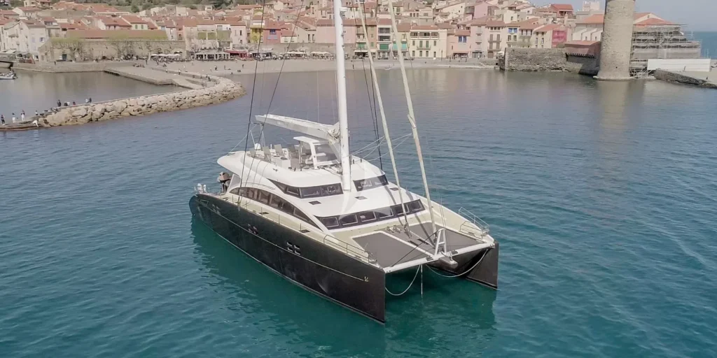 Bow view of Houbara catamaran deck and rigging in Collioure harbor