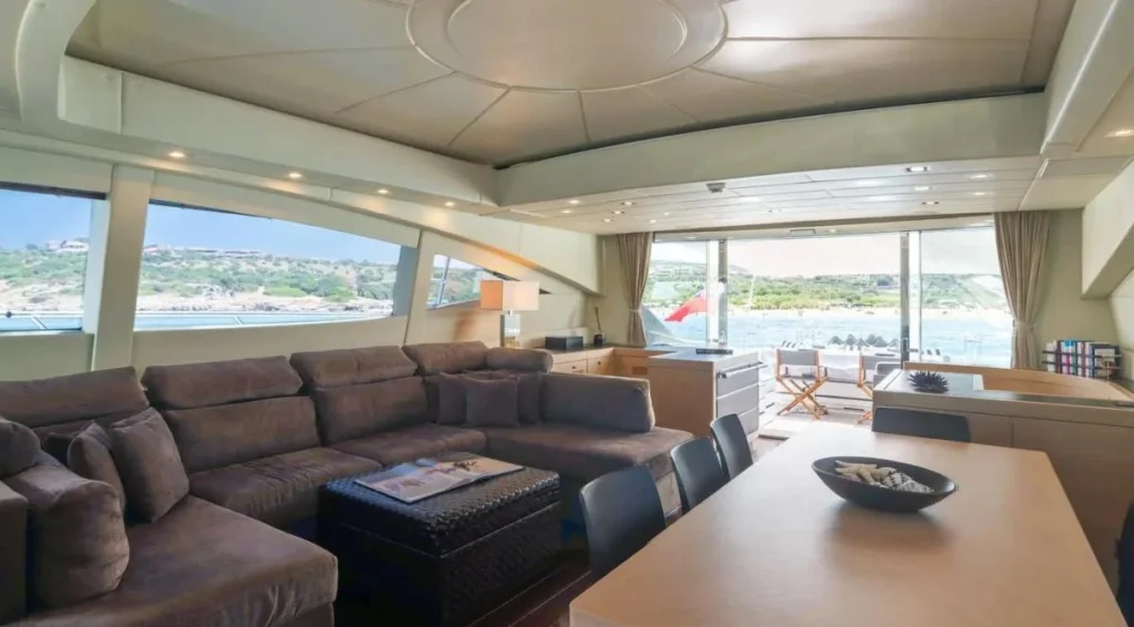 Main salon aboard Kawai with dining table and sofa