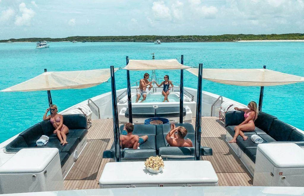 Foredeck lounge and jacuzzi aboard charter yacht Oculus with guests relaxing