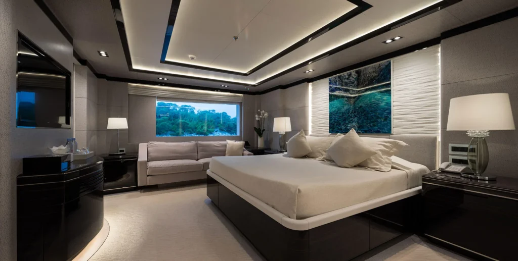 O'Ptasia yacht master suite bedroom with king bed and panoramic windows