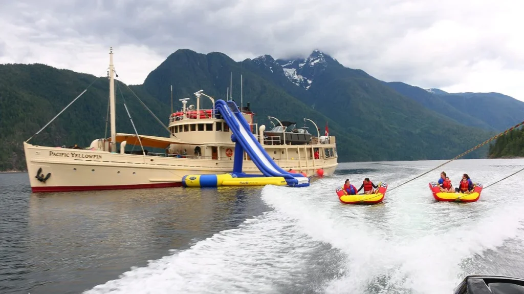 Pacific Yellowfin guests enjoying the inflatable waterslide and towables