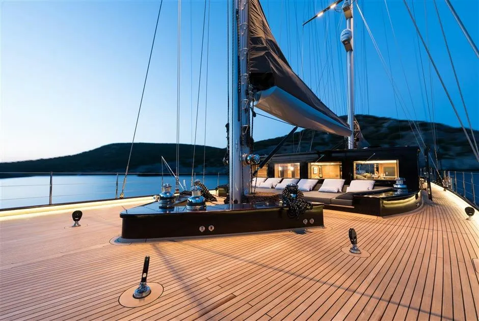 Aft deck dining and lounge area aboard M/Y Rox Star at dusk