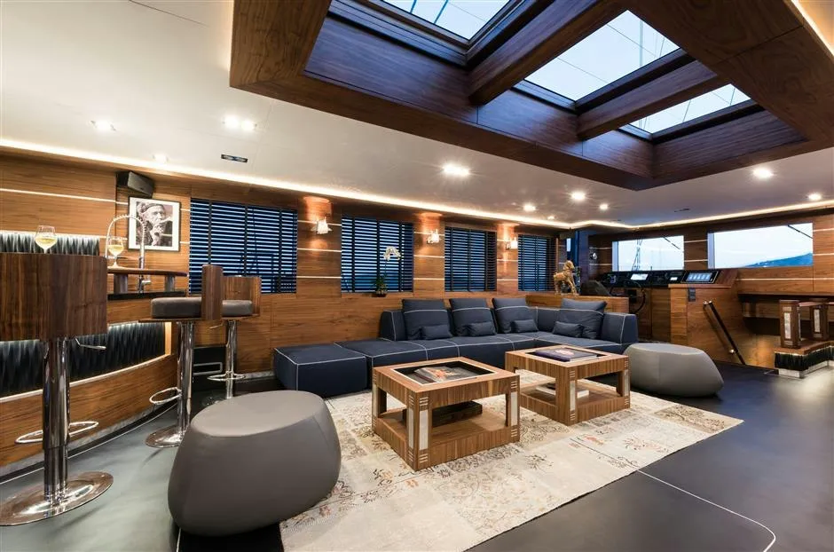 Main salon interior aboard M/Y Rox Star with walnut woodwork and lounge seating