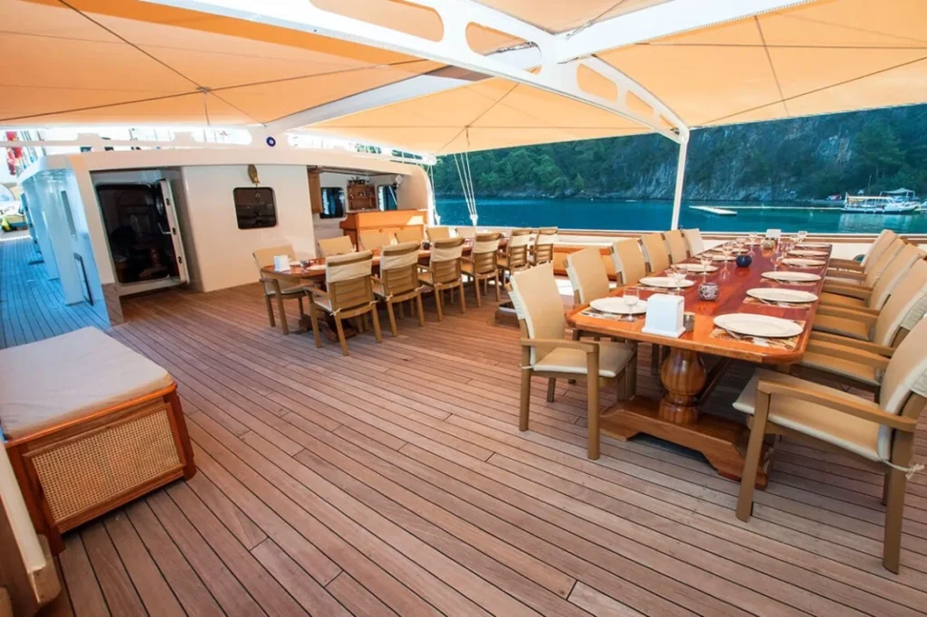 Guest cabin aboard Tersane 8 with a made-up double bed and wood-paneled interior