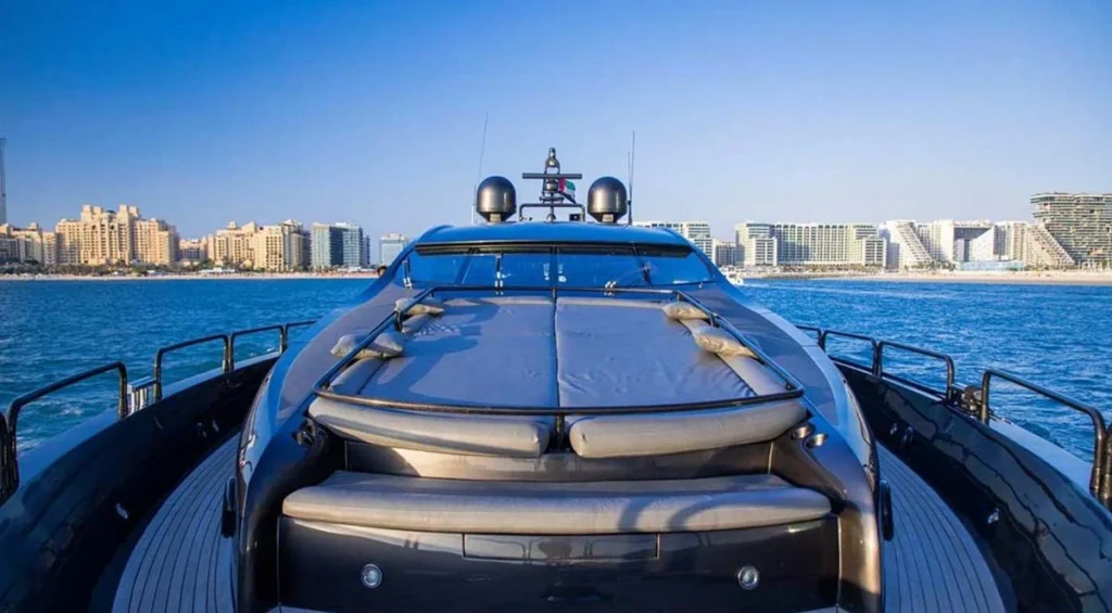 Foredeck sunpad seating area aboard UD30 with Dubai skyline in the background