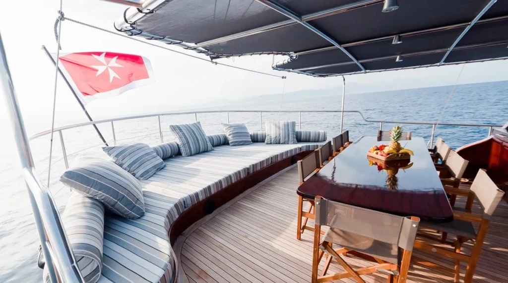 Vita Dolce yacht aft deck with dining table and lounge seating